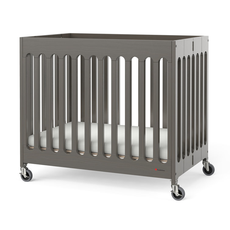 Rolling mini hot sale crib